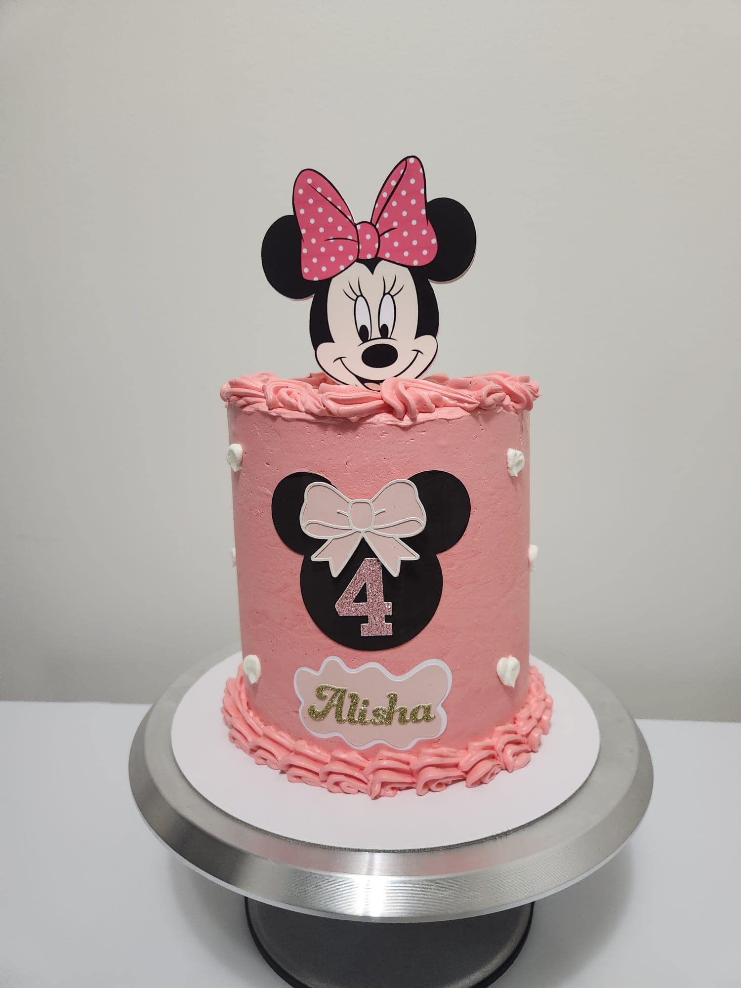 Custom pink Minnie Mouse-themed birthday celebration cake
