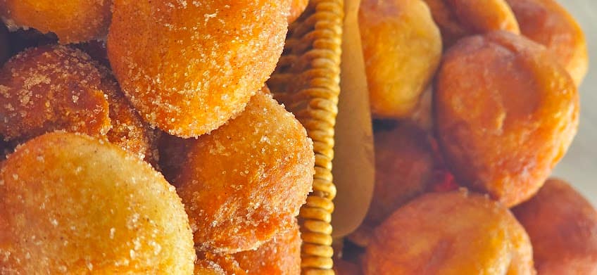 Golden puff-puff dusted in sugar