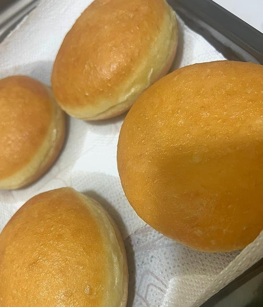 Freshly fried golden donuts resting on a tray